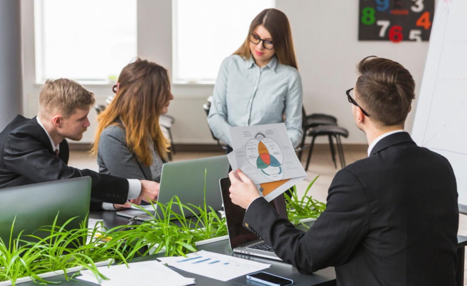 Professional workspace setup showing business planning materials and digital tools